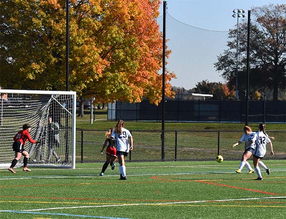 Eden Haldeman (#13 white) attempts a shot in the United East Semifinal Game.